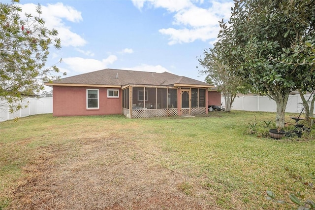 back of house featuring a sunroom and a yard