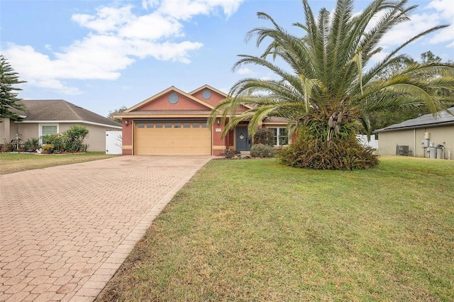 view of front of house featuring a garage, central AC unit, and a front yard