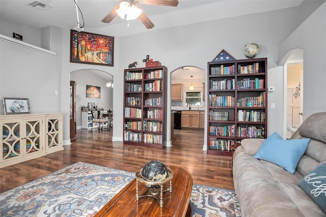 living room with ceiling fan, dark hardwood / wood-style floors, and sink