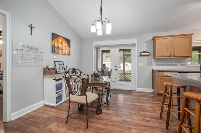 dining area featuring french doors, dark hardwood / wood-style floors, vaulted ceiling, and a wealth of natural light