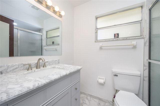 bathroom featuring vanity, walk in shower, and toilet