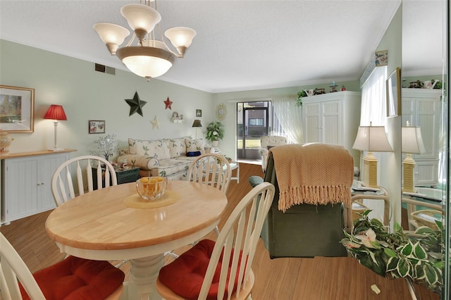 600 N Boundary Ave Unit 114B, Deland, FL 32720 - dining area featuring plenty of natural light, wood finished floors, and a textured ceiling
