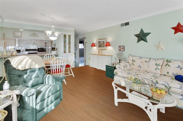 600 N Boundary Ave Unit 114B, Deland, FL 32720 - living room with crown molding, light wood-style flooring, and a textured ceiling