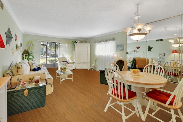 600 N Boundary Ave Unit 114B, Deland, FL 32720 - dining area featuring a textured ceiling, ornamental molding, healthy amount of natural light, and light wood-style flooring