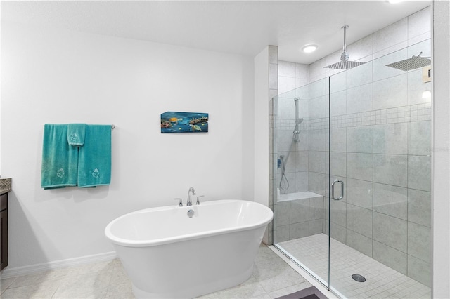 bathroom featuring independent shower and bath, vanity, and tile patterned floors