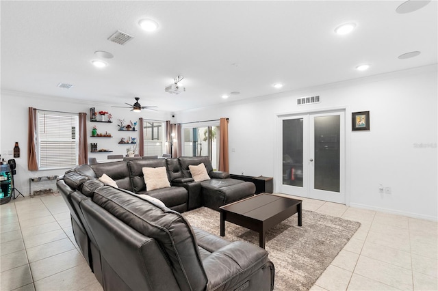 living room featuring french doors, ceiling fan, ornamental molding, and light tile patterned floors