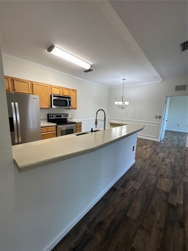 kitchen with sink, crown molding, hanging light fixtures, dark hardwood / wood-style floors, and stainless steel appliances