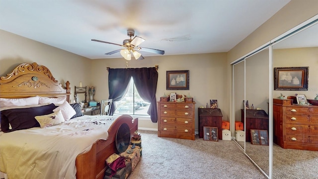 bedroom featuring light colored carpet, a closet, and ceiling fan