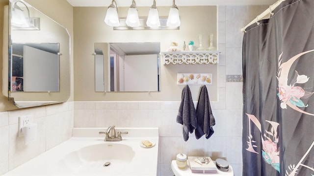 bathroom with sink, tile walls, and a shower with shower curtain