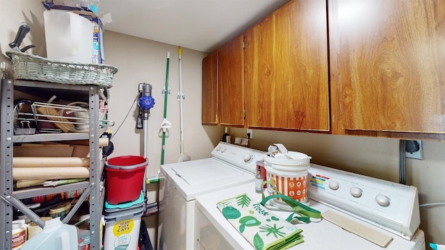 laundry room featuring cabinets and separate washer and dryer