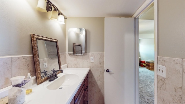 bathroom featuring vanity and tile walls