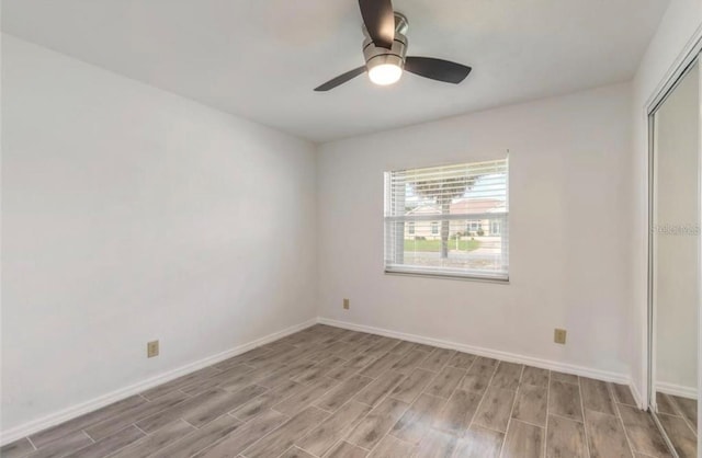 unfurnished bedroom with light hardwood / wood-style flooring, a closet, and ceiling fan