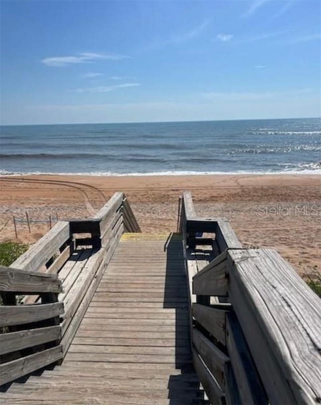 view of home's community featuring a water view and a view of the beach