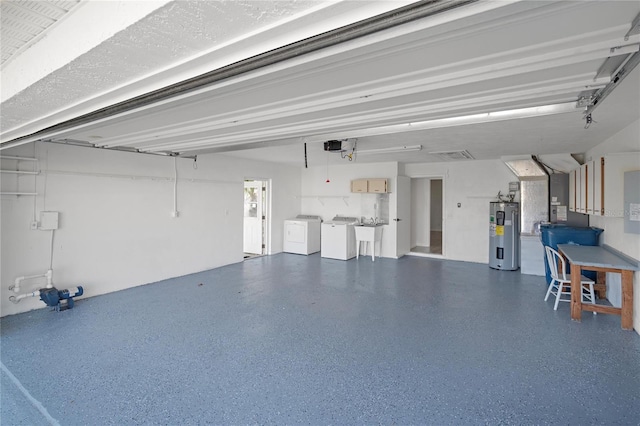 garage with water heater and independent washer and dryer