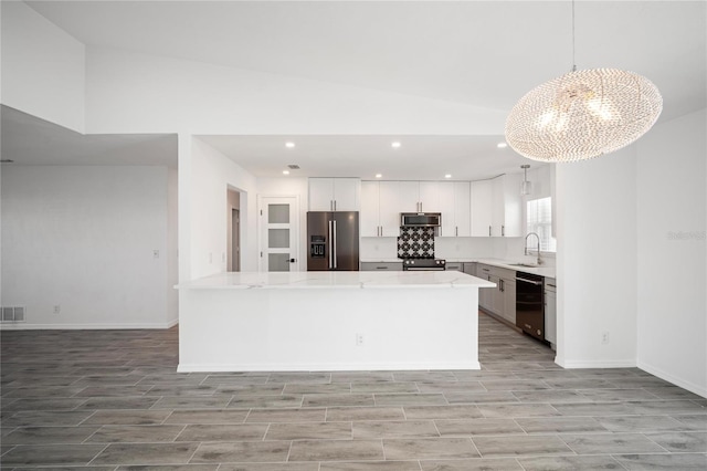 kitchen with sink, white cabinetry, an inviting chandelier, decorative light fixtures, and black appliances