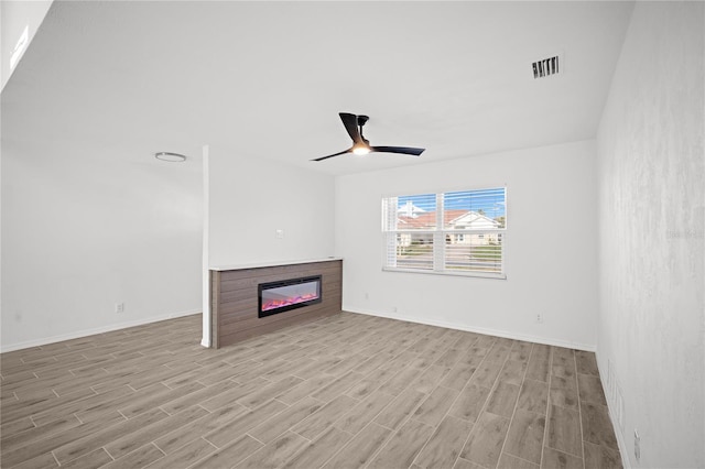 unfurnished living room with ceiling fan and light hardwood / wood-style floors