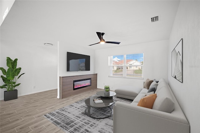 living room with ceiling fan and light hardwood / wood-style flooring