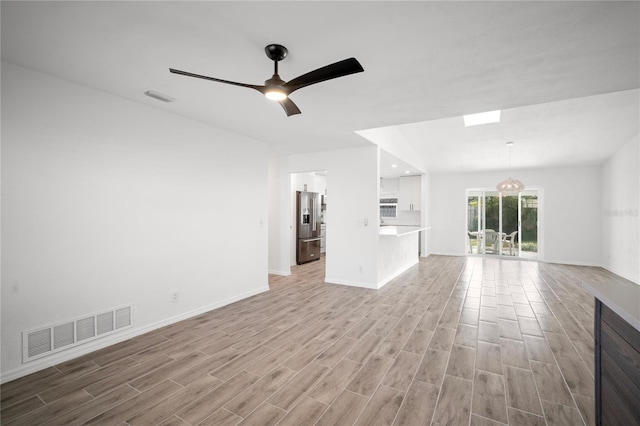 unfurnished living room with ceiling fan and light hardwood / wood-style floors