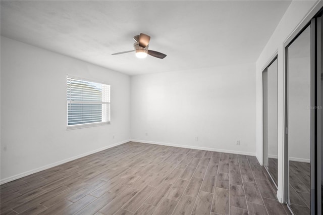 unfurnished bedroom with light hardwood / wood-style floors, a closet, and ceiling fan