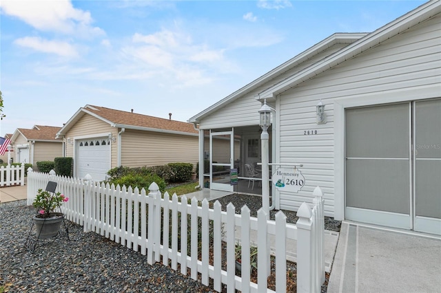 view of front of house featuring a garage and a sunroom