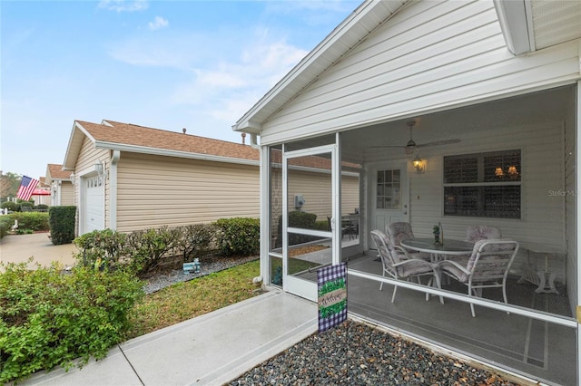 view of patio with a garage, a sunroom, and ceiling fan