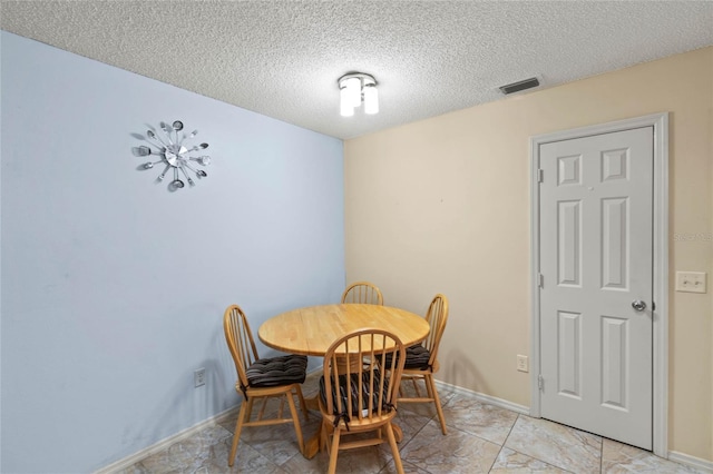 dining room featuring a textured ceiling