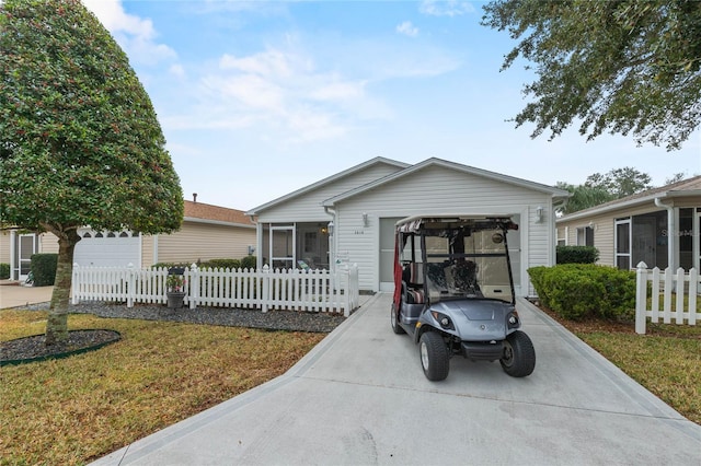 view of front of home with a garage, a front lawn, and a sunroom