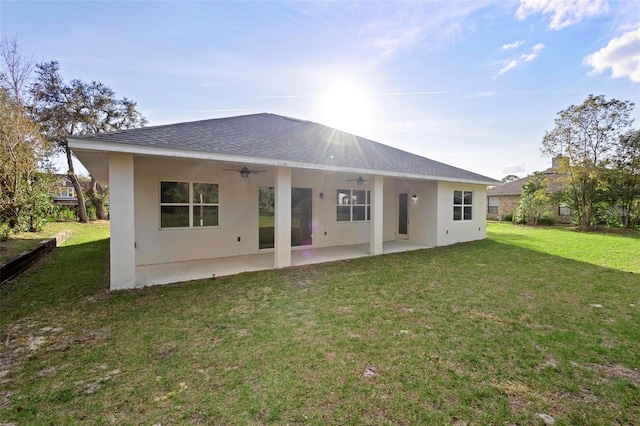 rear view of property featuring a yard, a patio area, and ceiling fan