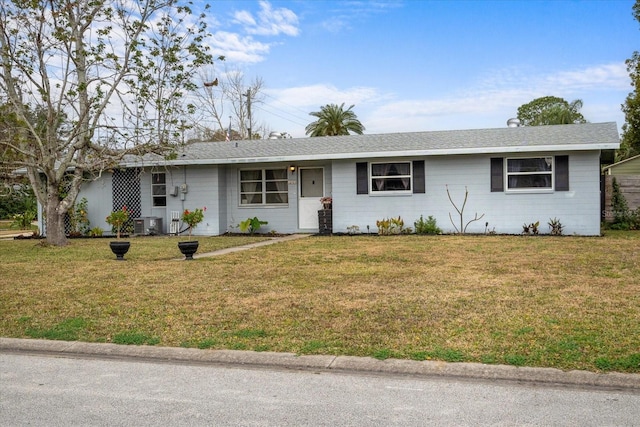 ranch-style house featuring central AC unit and a front yard