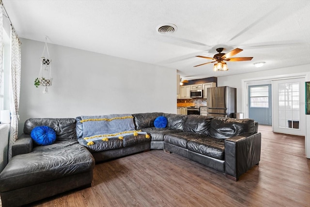 living room with hardwood / wood-style flooring and ceiling fan