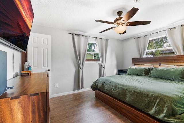 bedroom featuring ceiling fan and dark hardwood / wood-style flooring