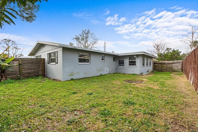 rear view of property featuring a yard