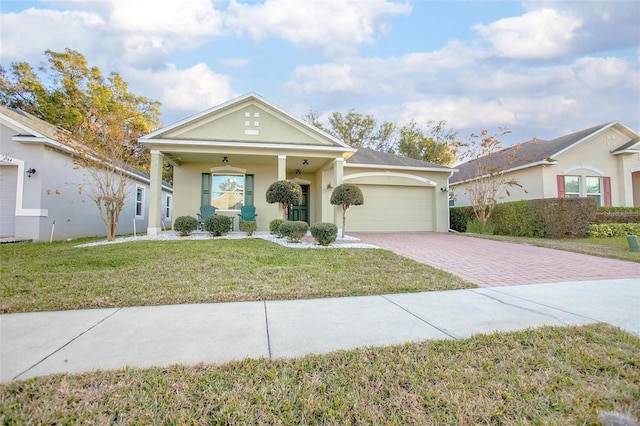 view of front of property featuring a garage, a front yard, and covered porch