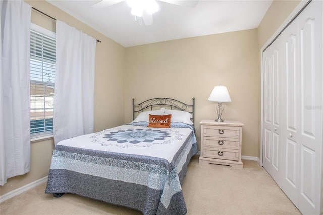 carpeted bedroom with a closet and ceiling fan