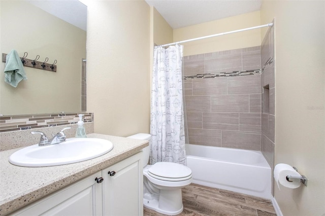 full bathroom featuring vanity, hardwood / wood-style floors, toilet, and shower / bath combo with shower curtain