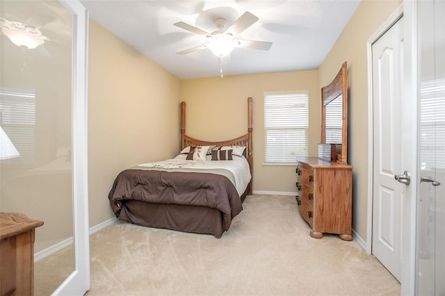 bedroom with ceiling fan and light colored carpet