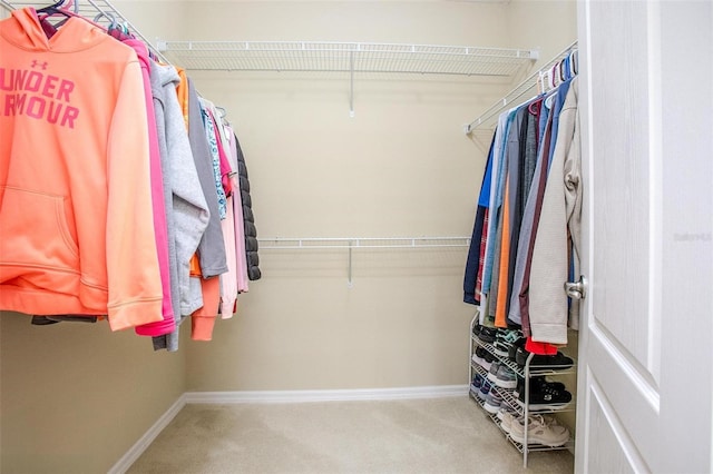 walk in closet with carpet