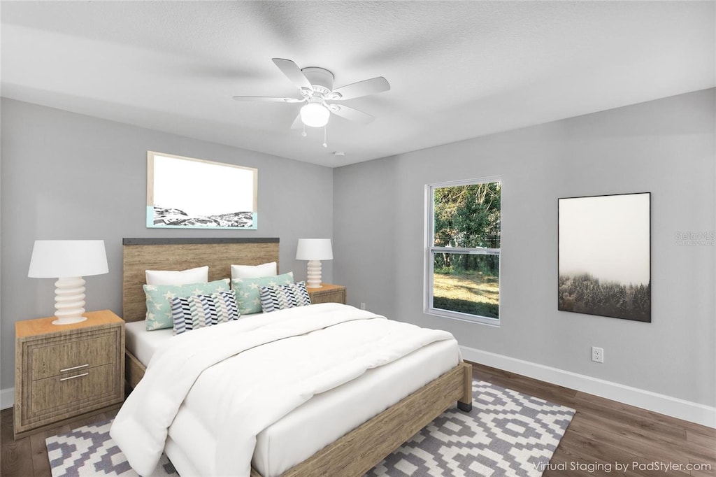 bedroom with ceiling fan and dark hardwood / wood-style flooring