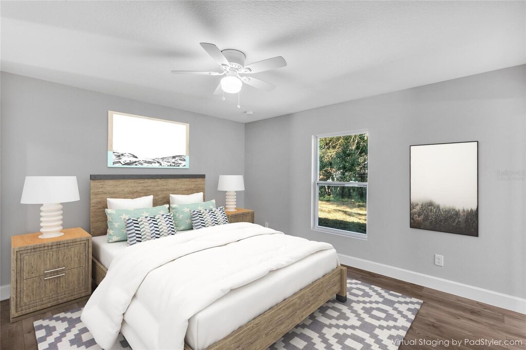 bedroom featuring ceiling fan, baseboards, and wood finished floors