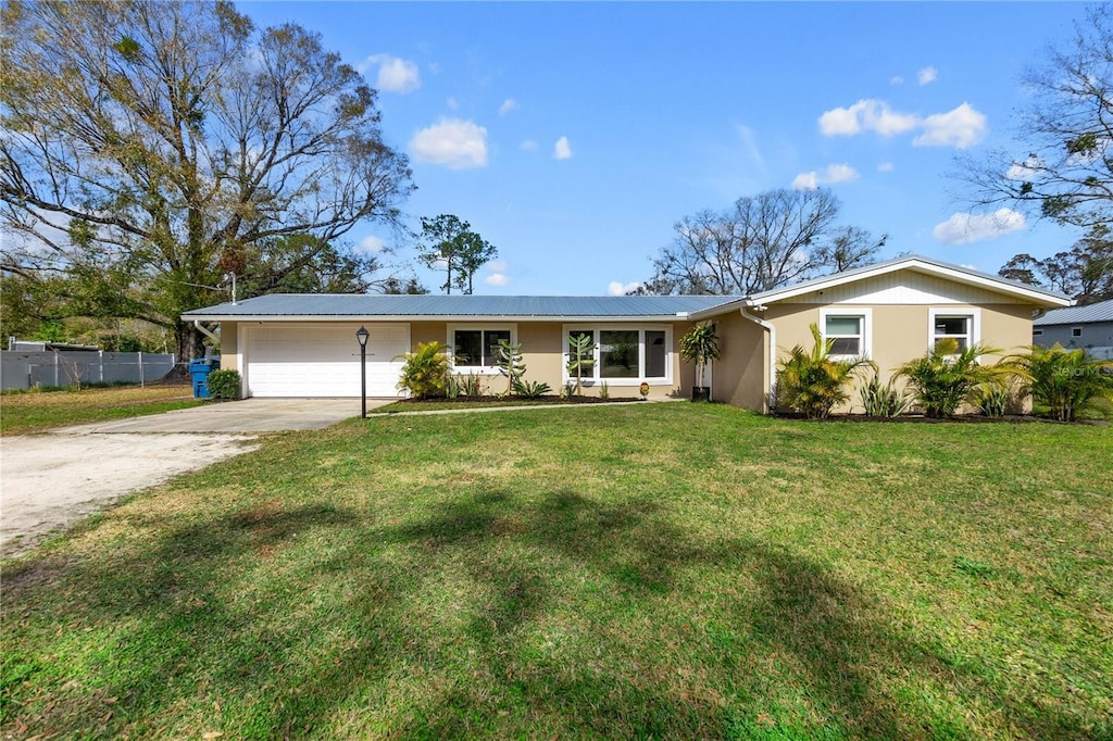 single story home with a garage and a front yard