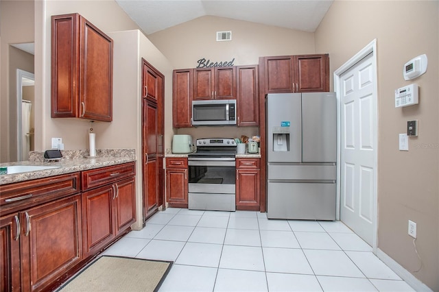 kitchen featuring stainless steel appliances, light tile patterned flooring, lofted ceiling, and sink