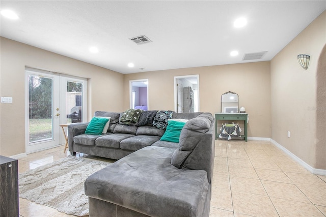 living room featuring light tile patterned floors and french doors