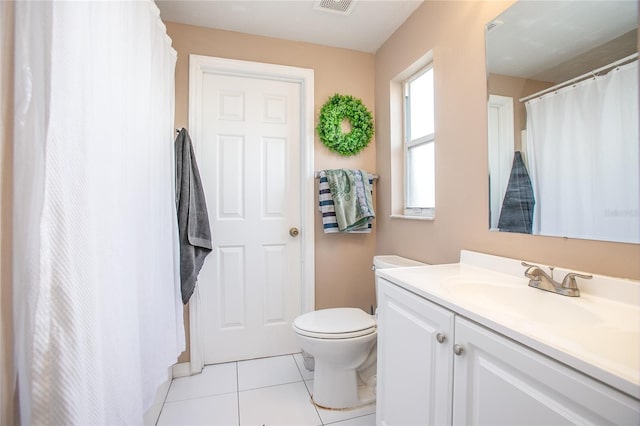 bathroom with vanity, tile patterned floors, and toilet