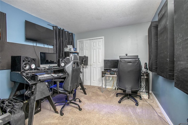 carpeted home office featuring a textured ceiling