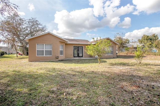 back of property with a lawn