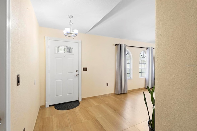 foyer entrance featuring a chandelier