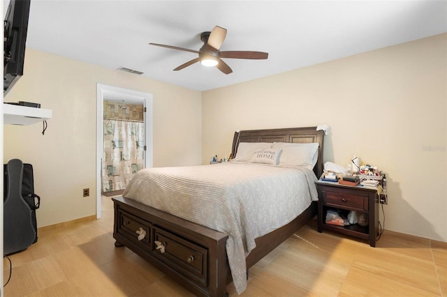 bedroom featuring ceiling fan and ensuite bath