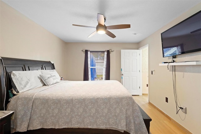 bedroom with ceiling fan and light hardwood / wood-style flooring