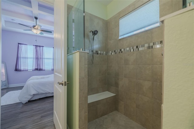 bathroom with a tile shower, hardwood / wood-style flooring, and ceiling fan