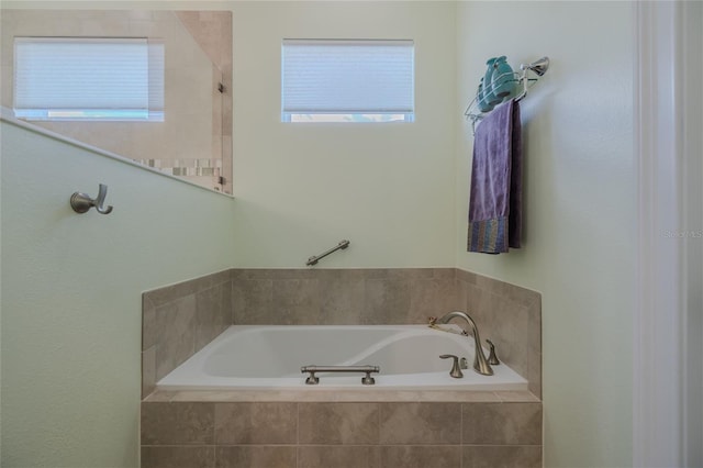 bathroom with a relaxing tiled tub